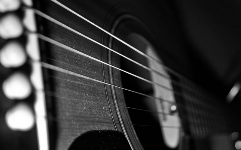 plucking an instrument, musical equipment, monochrome, close-up, string, no people, selective focus, arts culture and entertainment, brown, wood - material