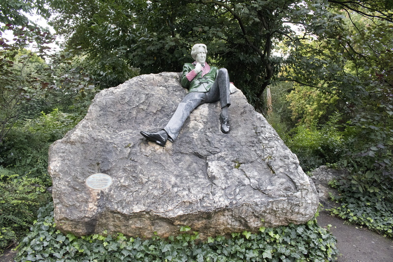 mature men, solid, rock, oscar wilde sculpture, nature, land, outdoors, places of interest, growth, plant, tree, lifestyles, leisure activity, monument