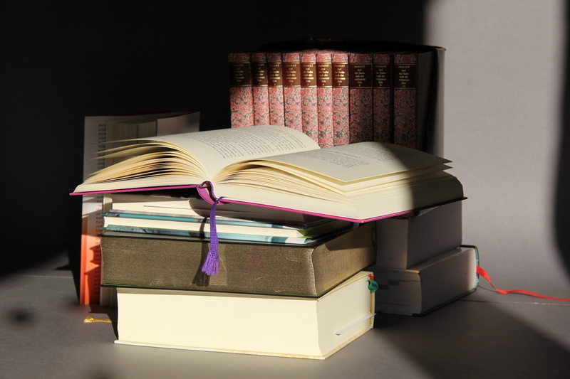group of objects, cover, hardcover book, still life, absence, bound, indoors, furniture, light and dark, read, bookworm, wisdom, table, open, publication