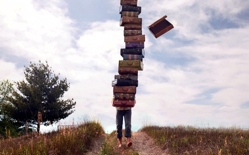 man, cloud - Sky, sign, blue, no people, balance, grass, direction, non-urban scene, outdoors, mountain, pile, landscape, guidance, wood - Material, set