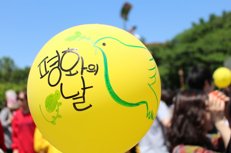 day, dove, yellow, outdoors, smiling, celebration, creativity, inflatable, animal representation, incidental people, focus on foreground, summer, animal