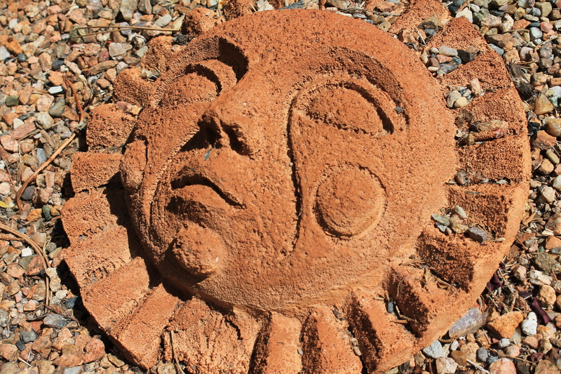 outdoors, rock - object, handmade, sun face, history, xeriscape, communication, ancient civilization, southwestern art, garden, anthropomorphic, text, xeriscaping