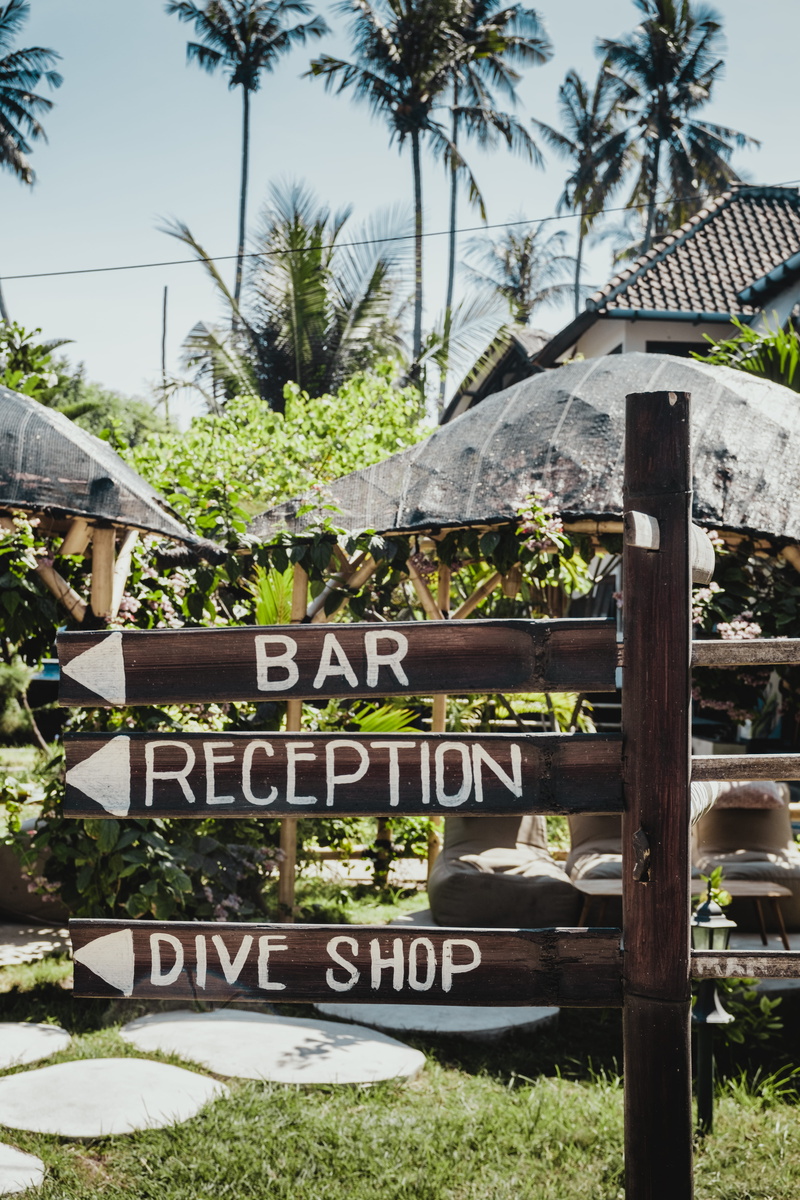 tropical climate, building exterior, sign, outdoors, holidays, nature, wood, sunlight, bali, architecture, text, day, plant, 5K, no people, built structure
