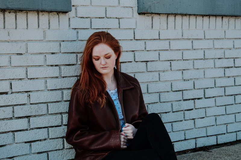 near, lifestyles, young women, wall - building feature, one person, casual clothing, woman, redhead, long hair, standing, girl with freckle, brick, architecture