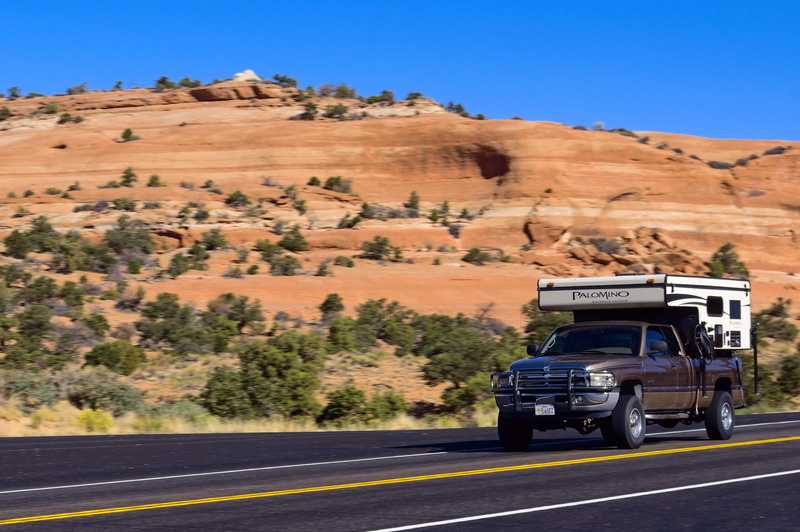 mode of transportation, plant, transportation, blur, motor vehicle, vehicle, camping, clear sky, non-urban scene, sky, car, highway, day, landscape, lifestyle