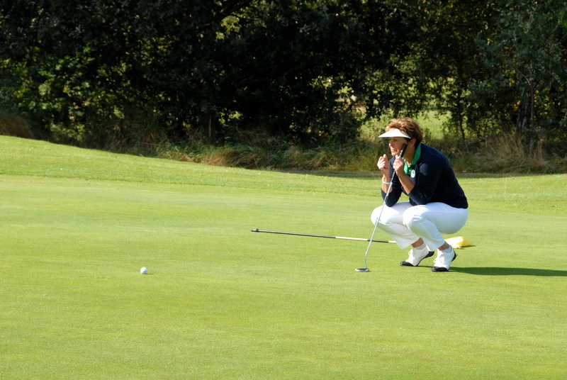 green color, outdoor, golfing, skill, competition, golfer, holding, casual clothing, green - golf course, leisure activity, waiting, hole, club, summer