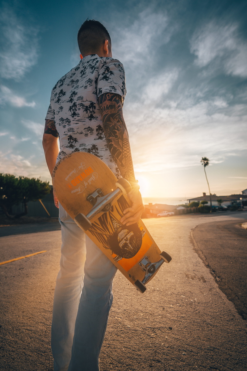 road, male, coast, skateboard, outdoors, street, outdoor, person, tattoo, guy, flare, asphalted, sunshine, summer, people, sunlight, holding, palm, cloud