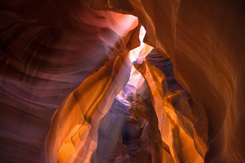 low angle view, geology, nature, non-urban scene, adult, rock formation, people, rock - object, indoors, sunlight, rock, eroded, travel destinations, beauty in nature