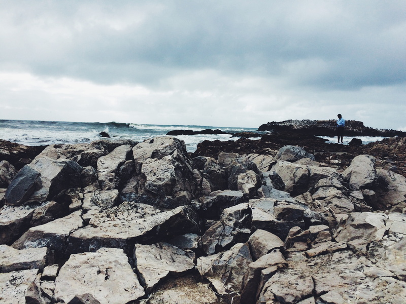 rock - object, rugged, scenics - nature, craggy, sea, day, dark clouds, beach, view, ocean, rocky, beauty in nature, tranquility, real people, outdoors