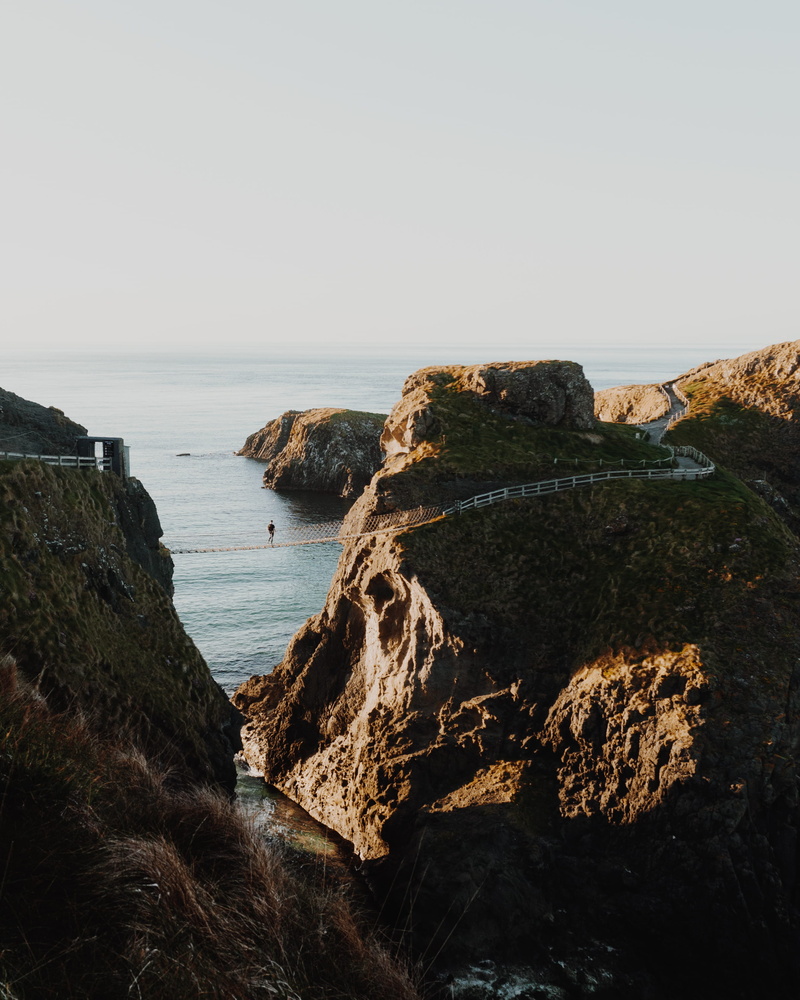 clear sky, beauty in nature, rock formation, cliff, solid, horizon over water, scenics - nature, person, lock screen background, tranquility, outdoors