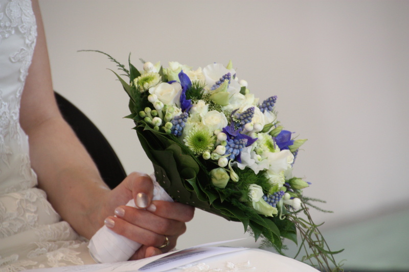 wedding ceremony, human hand, hand, one person, newlywed, human body part, wife, bunch of flowers, flower arrangement, white, bride, plant, event, blue