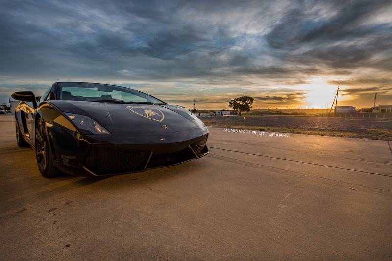 Lamborghini Gallardo, air vehicle, sunset, outdoors, no people, 5K, transportation, sky, mode of transportation, road, land vehicle, travel, city, luxury