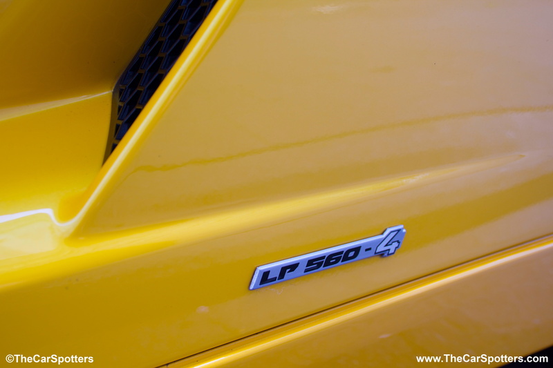 western script, high angle view, 5K, text, no people, Lamborghini Gallardo, metal, motor vehicle, transportation, day, car, yellow, backgrounds, communication