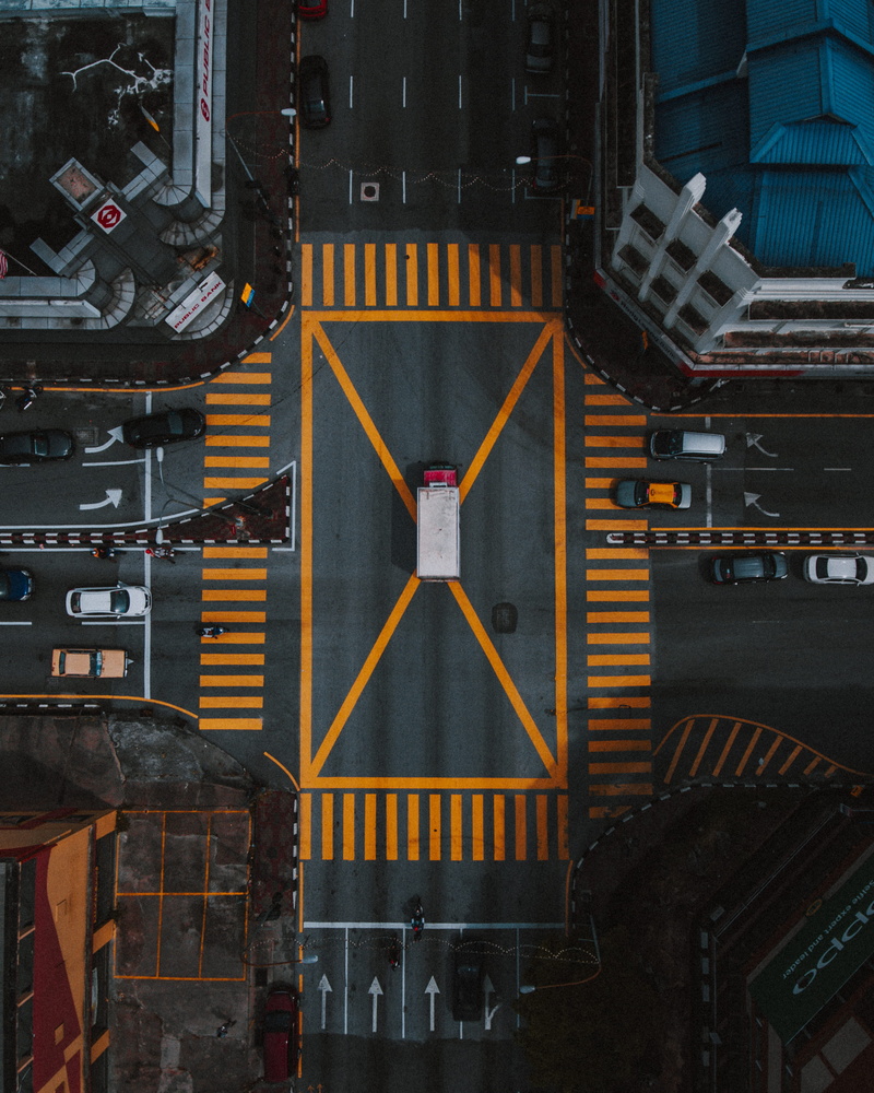 pedestrian crossing, aerial, architecture, mode of transportation, road, text, cars, city, vehicles, pedestrians, communication, zebra crossing, road marking
