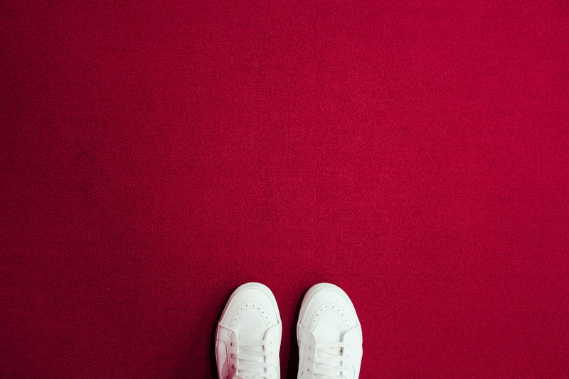 shoe, carpet - decor, lifestyles, one person, jeans, human foot, high angle view, unrecognizable person, 5K, lace, human limb, white, red, shoes, human body part