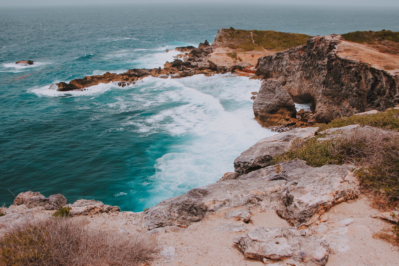 water, cave, coast, formation, rocky coastline, solid, outdoors, paradise, rock - object, shoreline, cliff, motion, tranquility, rock formation, rock, no people