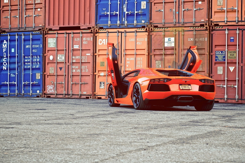 mode of Transport, land Vehicle, car, motor vehicle, guillotine, aventador, industry, built structure, shipping, city, orange, commercial dock, doors, outdoors