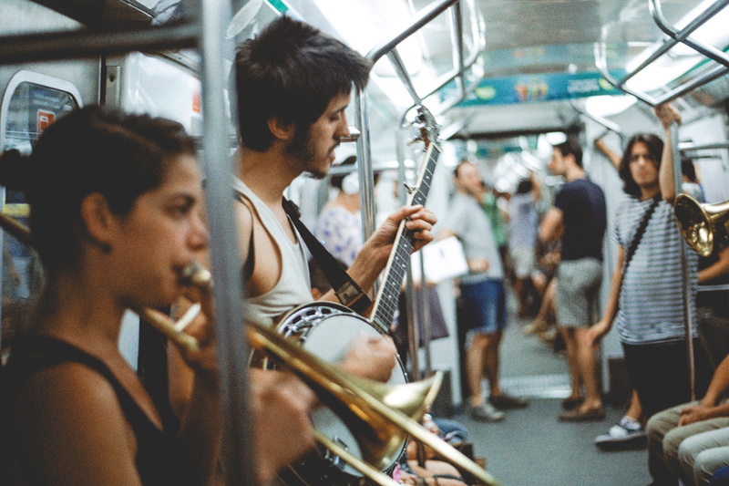mode of transportation, trumpet, station, casual clothing, young men, indoors, real people, playing, men, holding, music, group of people, guitar, adult