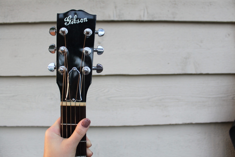 head, human finger, human body part, holding, human hand, music, musical instrument, day, one person, hand, personal perspective, black, gibson, arts culture and entertainment
