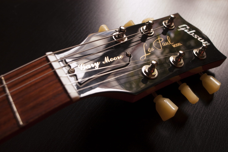 instrument, black color, wood - material, close-up, black background, selective focus, strings, string instrument, no people, handgun, electric, indoors