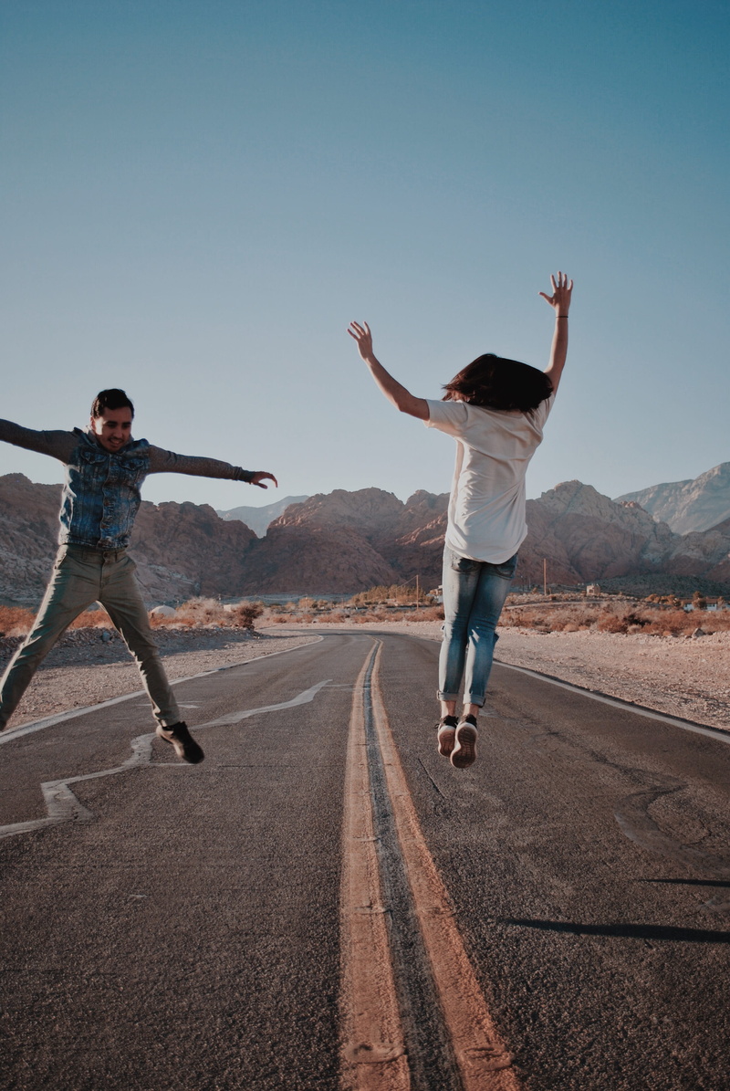 jumping, apparel, shoe, dance pose, leisure activity, transportation, emotion, men, clothing, lifestyles, denim, two people, exercise, footwear, arms raised