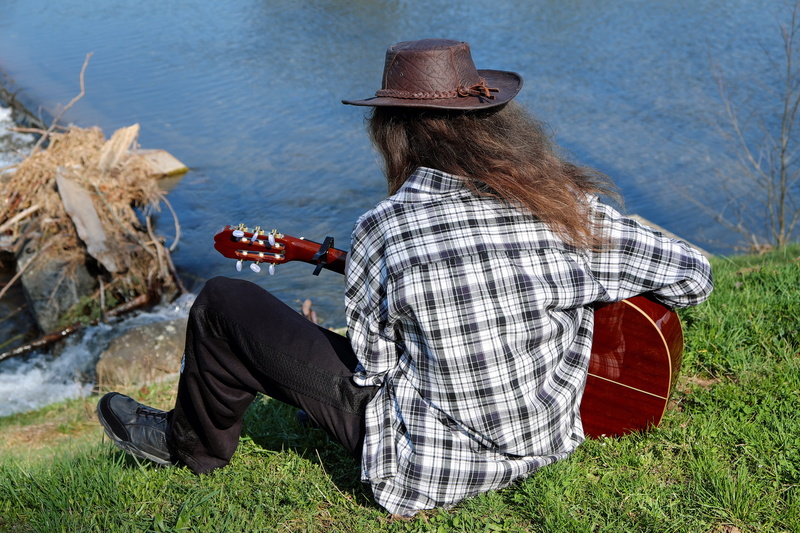 real people, 4K, lifestyles, lake, water, plays, outdoors, out, classical guitar, rock - object, plant, near, guitar player, body, land, daytime, musician