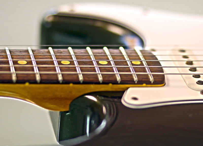 soundbody, fender, woodwind instrument, indoors, playing, musical Instrument String, bass guitar, setting, still life, music, studio shot, macro, single Object