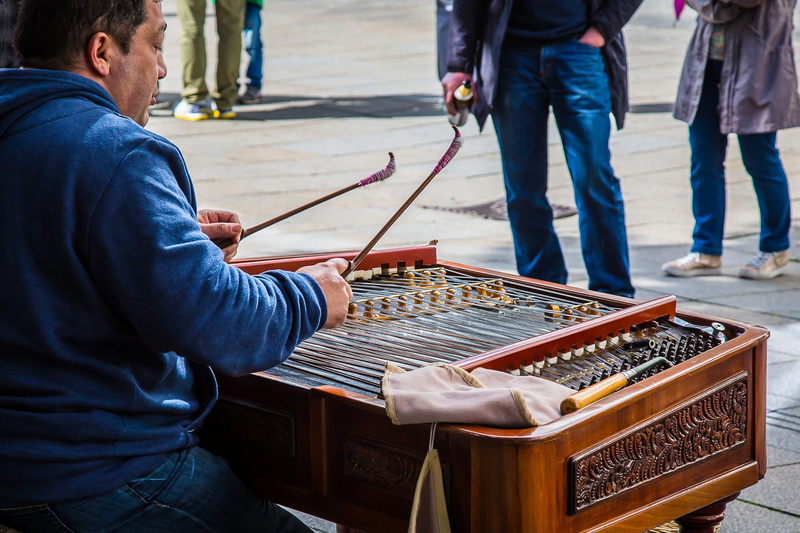 people, musical instrument, street, dulcimer, midsection, market, adult, stringed instrument, city, zither, holding, men, standing, lifestyles, street musicians