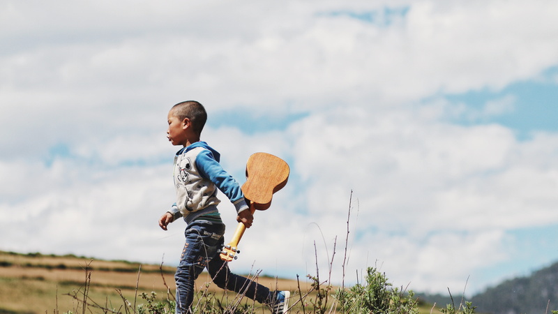 field, enjoyment, lifestyles, cloud - sky, blue, offspring, guitar, two People, three quarter length, 5K, family, standing, ukelele, hoodie, copy Space
