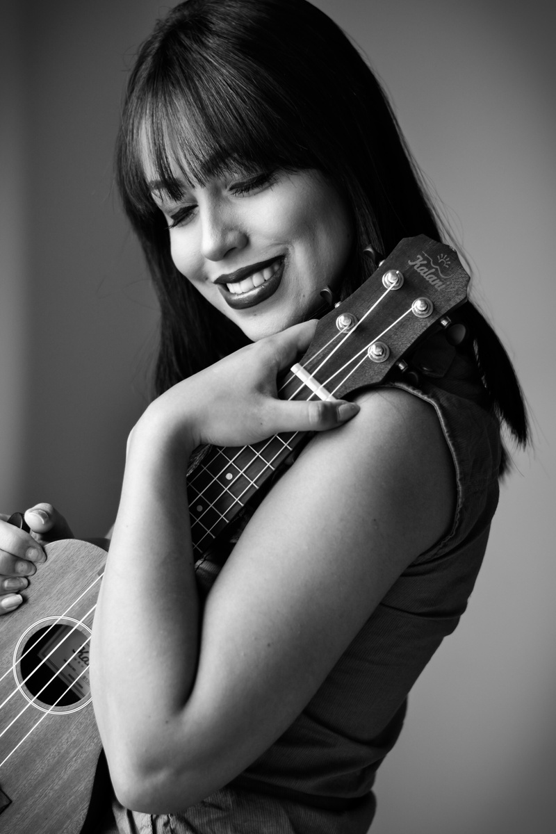 fretboard, playing, greyscale, monochrome, eyes, bangs, smiling, pretty, hair, photo, attractive, lady, photoshoot, real people, happiness, string instrument