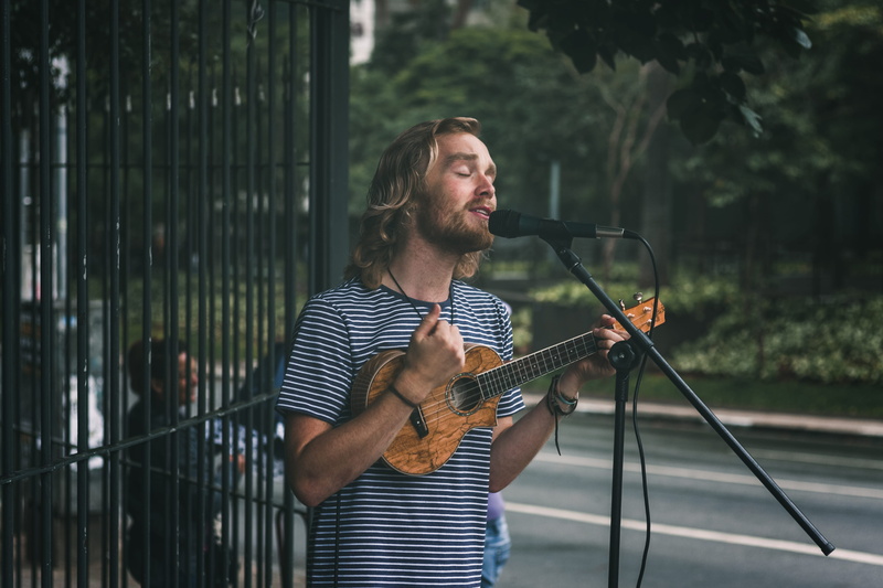 ukelele, real people, 4K, singing, arts culture and entertainment, adult, man, casual clothing, playing, road, music, lifestyles, leisure activity, holding