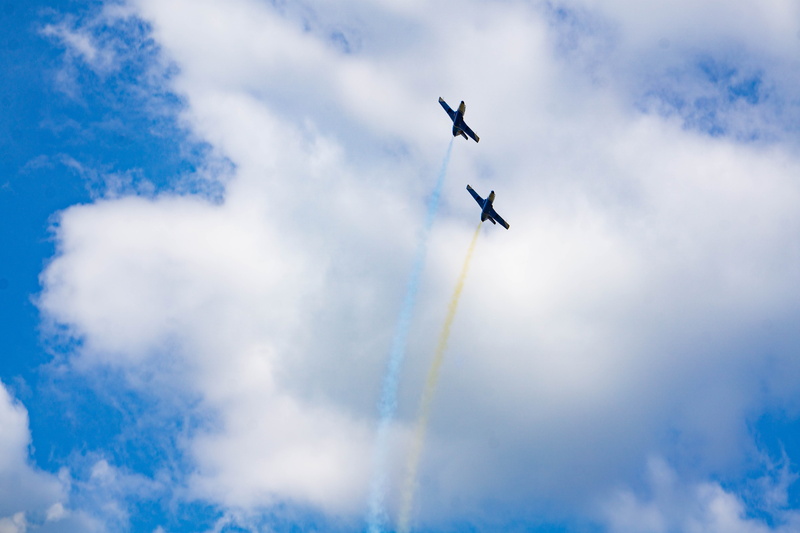 day, travel, air vehicle, blue, speed, transportation, smoke - physical structure, vapor trail, fighter plane, flag, sky, low angle view, no people, directly below