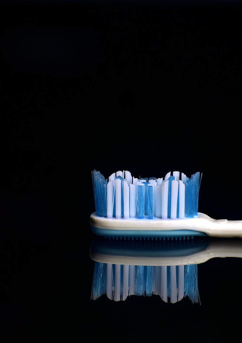 black background, single object, 2K, macro, white color, blue, eating utensil, cupcake holder, freshness, cut out, copy space, reflection, teeth, no people