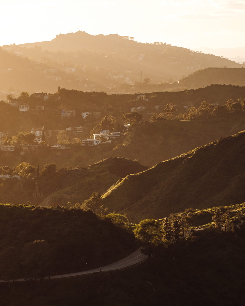 mountain, countryside, road, beauty in nature, non-urban scene, sunset hills, environment, light, idyllic, sun beams, mountain range, high angle view, tranquil scene