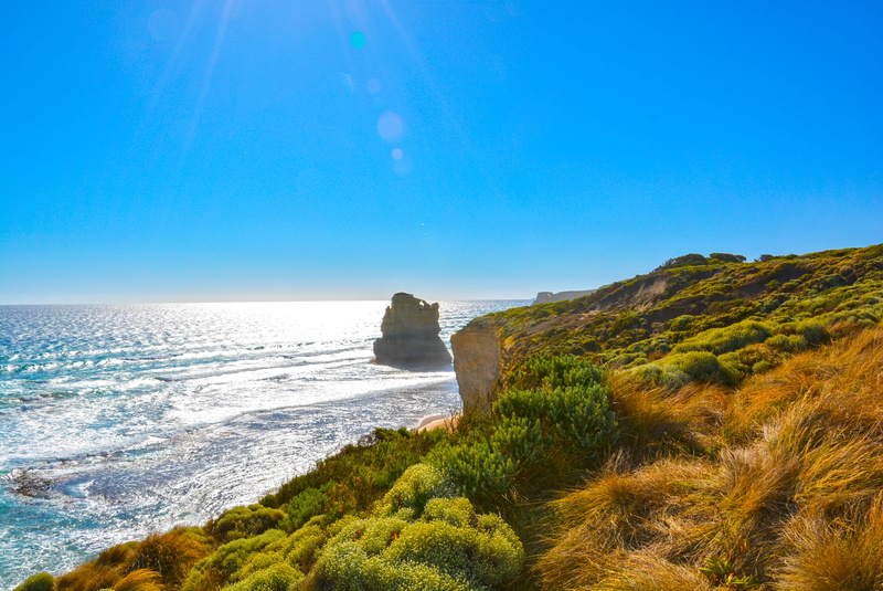 sky, rock formation, bay, surf, grass, seashore, tranquility, scenic, scenics - nature, sea, clear sky, aquatic sport, vacation, seascape, landscape, island
