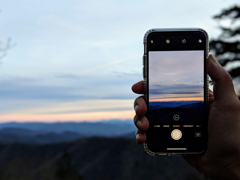 holding, angles, finger, person, digital camera, united states, sky, cloud - sky, sunset, outdoors, wireless technology, technology, electronics, phone