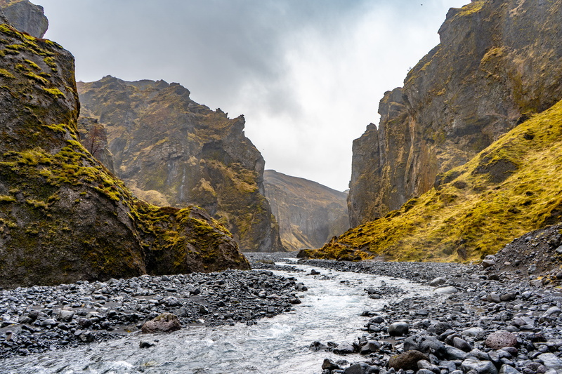 mountain, road, no people, rock - object, eroded, gravel, solid, dirt road, valley, scenery, flowing water, sea, sky, canyon, outdoors, tranquil scene