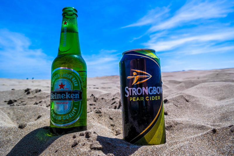 heinekein, green color, sunlight, day, close-up, Beach, outdoors, focus on foreground, container, message, drink, mediterranean, Cider, sea, beer Bottle