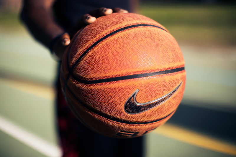 player, single object, human body part, orange color, people, street, sports backgrounds, person, athlete, close-up, playground, baller, holding, sportsman