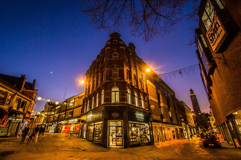 building, city street, incidental people, architecture, travel destinations, in the evening, car, norwich, city, transportation, dusk, sky, land vehicle