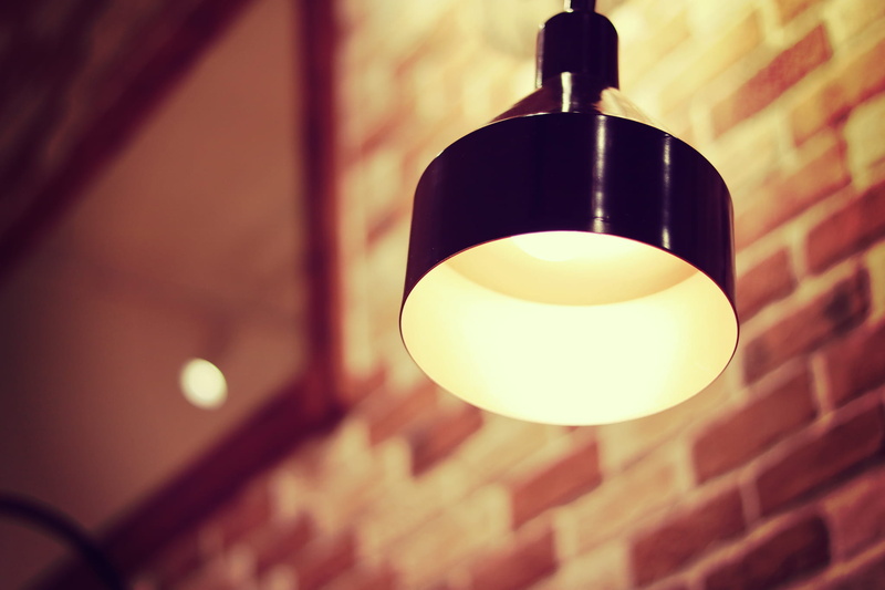 close-up, pendant light, lighting Equipment, ceiling, bulb, decoration, lamp shade, low angle view, black light, light, electricity, hanging, brick, wall - Building Feature