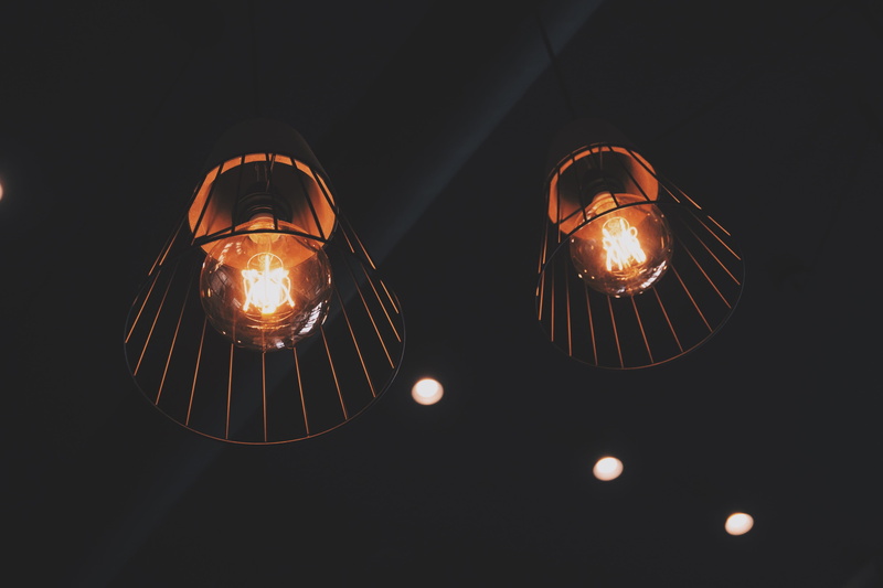 copy space, black background, decoration, fuel and power generation, hanging, light, colors, domestic room, lightbulbs, hanging lights, studio shot, low angle view