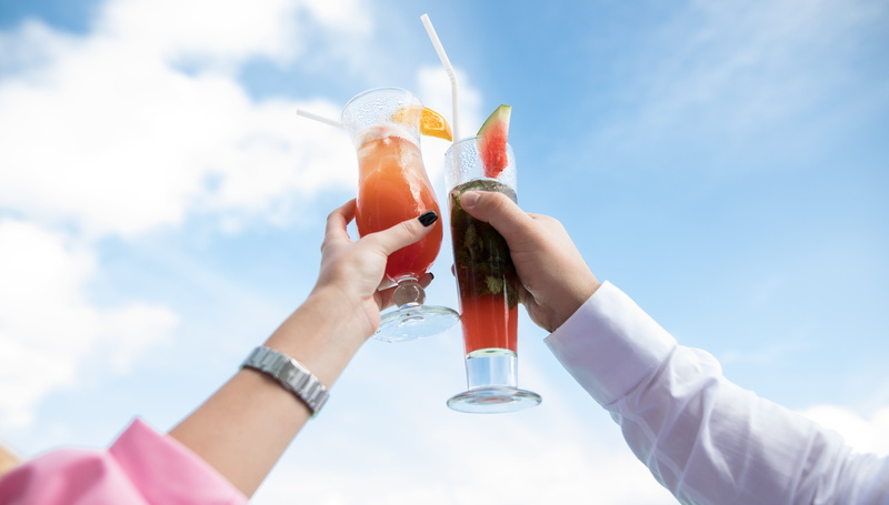 low angle shot, holding, cocktail, people, celebratory toast, health, refreshment, human, food, sky, liquid, cheers, outdoors, adult, summer, hand, glass