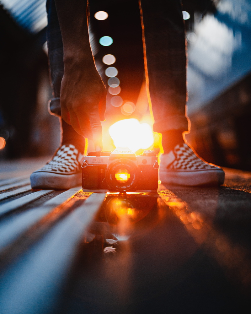 lens flare, low section, 4K, sunset, black, body part, real people, human leg, indoors, selective focus, heat - temperature, analog camera, fun, camera