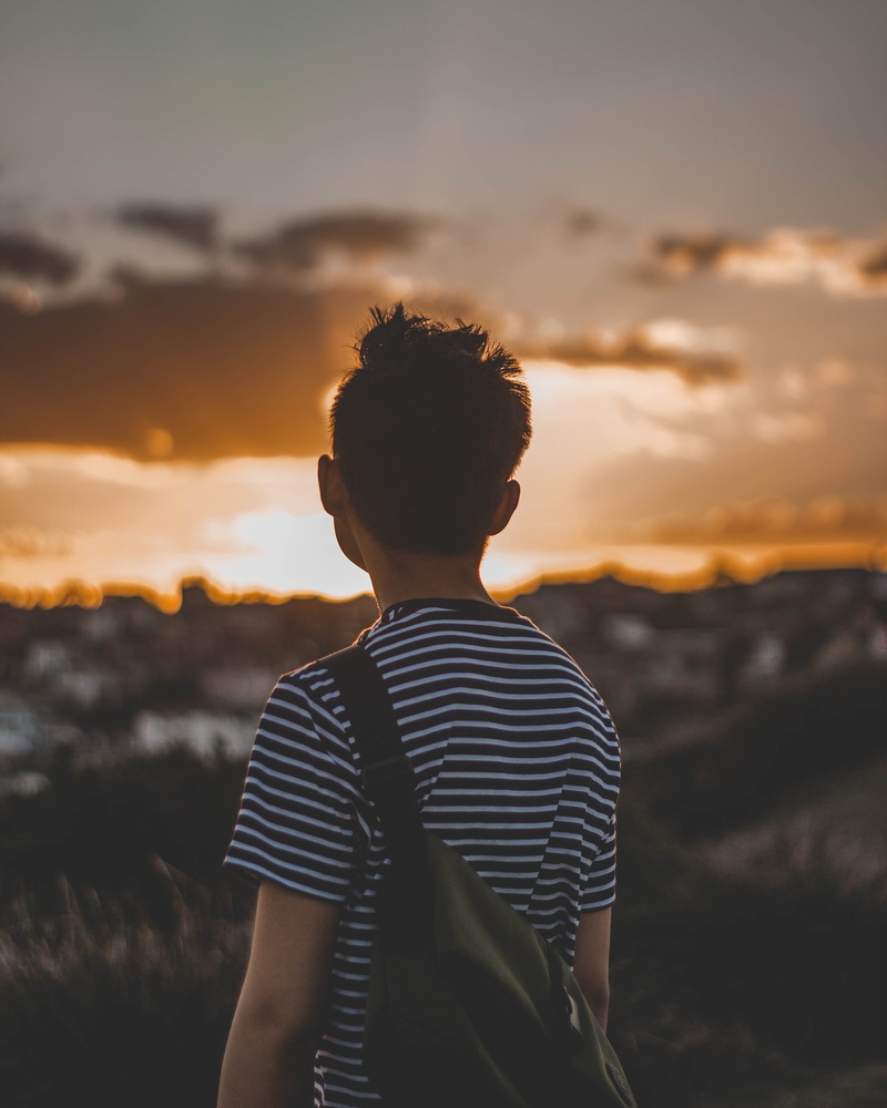 lifestyles, scenics - nature, one person, sunset, standing, hairstyle, sky, australia, real people, waist up, striped, looking at view, cloud - sky, tranquility