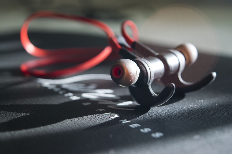 focus on foreground, red, arts culture and entertainment, personal accessory, earbuds, day, close-up, united states, indoors, listening, macro, still life
