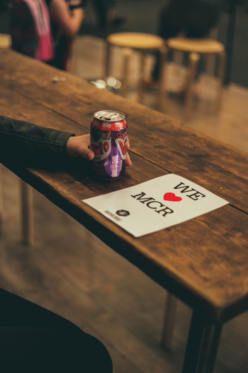 arts culture and entertainment, selective focus, sodacan, beverage, mcr, e, wood - material, lifestyles, community, high angle view, gambling, sign, leisure games