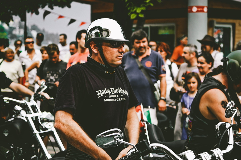 black shirt, rider, parade, clothing, black, focus on foreground, protection, blur, uniform, incidental people, depth of field, group of people, cap, festival