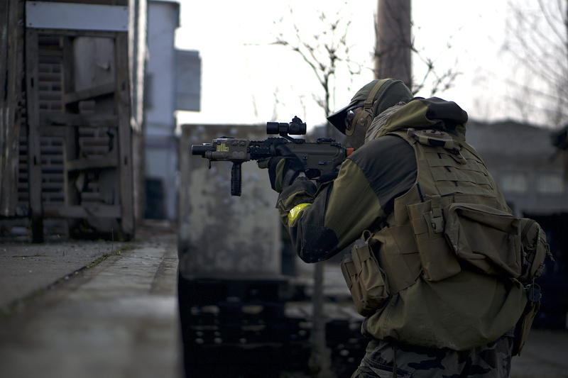 standing, building exterior, rear view, near, nature, tree, aifsoft, security, architecture, 2K, gun, uniform, government, soldier, rifle, weapon, person