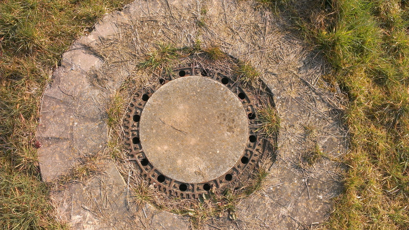 no people, sewer, shape, day, sewage system, wheel, hole, tree, gulli, street, outdoors, land, textured, textured effect, sewage, manhole, design, nature
